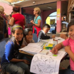 Children coloring at the shelter.